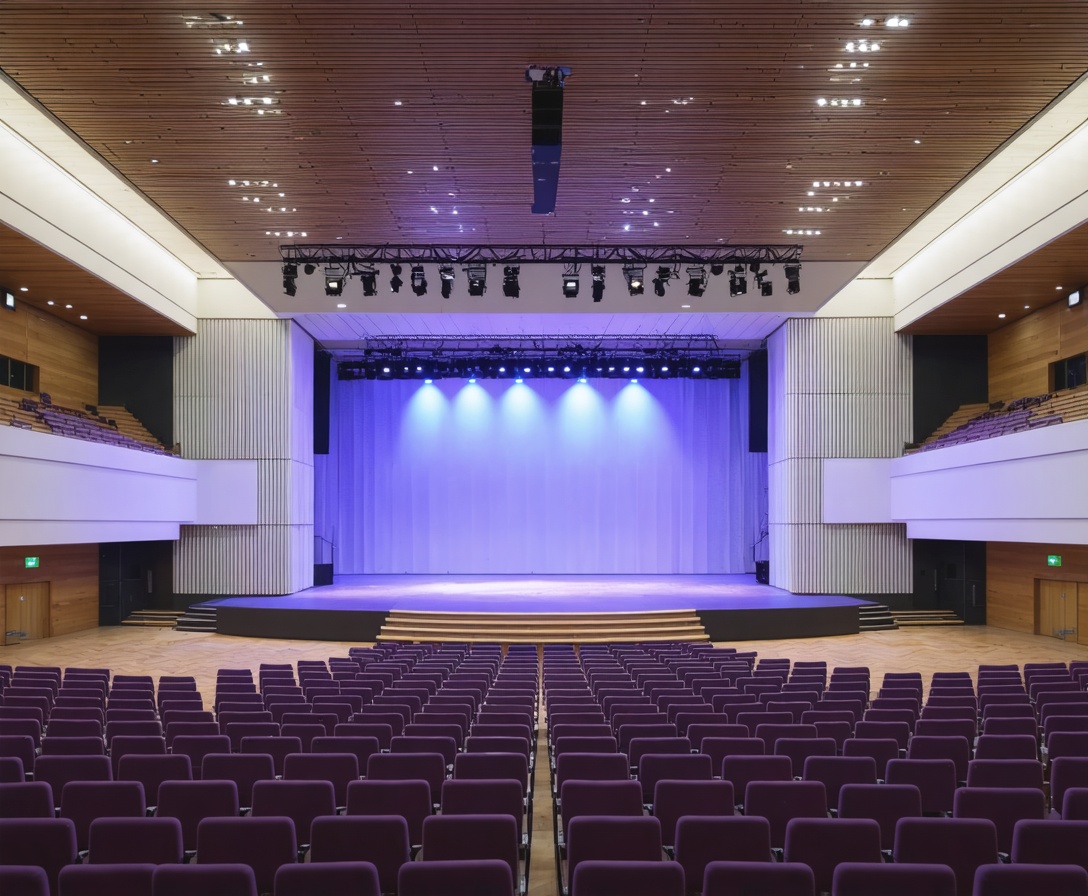 A modern conference hall with purple seating, representing the professional environments where our clients excel